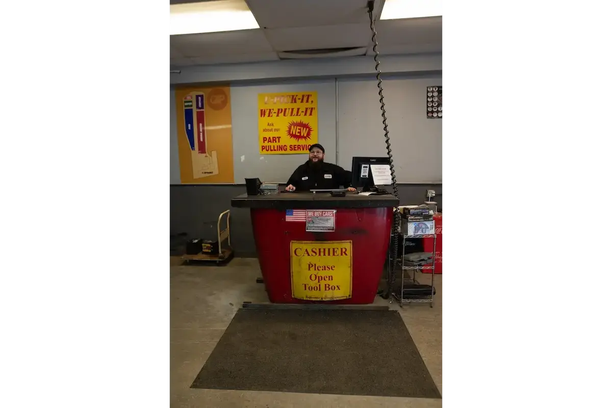 Employee sitting behind cashier's desk